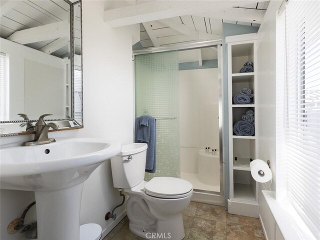 bathroom featuring toilet and an enclosed shower