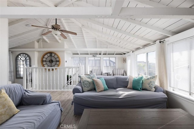 sunroom / solarium with vaulted ceiling with beams, ceiling fan, and wood ceiling