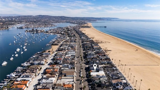 birds eye view of property featuring a view of the beach and a water view