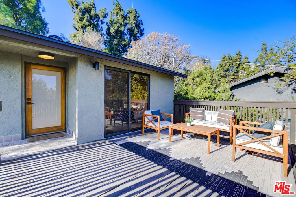 wooden terrace featuring outdoor lounge area