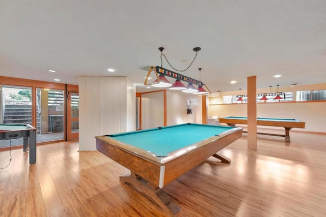 playroom featuring a tiled fireplace, pool table, and light hardwood / wood-style floors