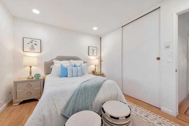 bedroom featuring light hardwood / wood-style flooring and a closet