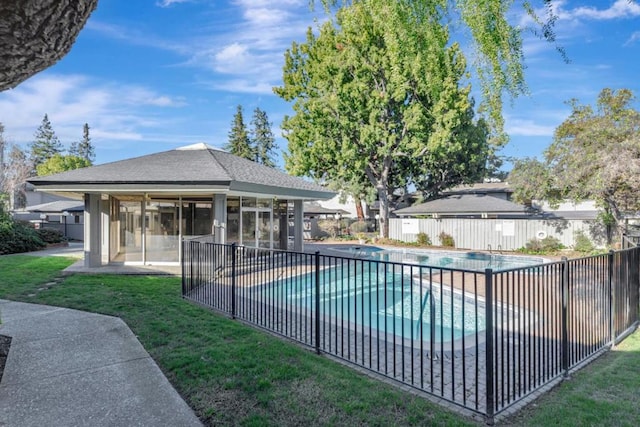 view of pool featuring a sunroom, a yard, and a patio area