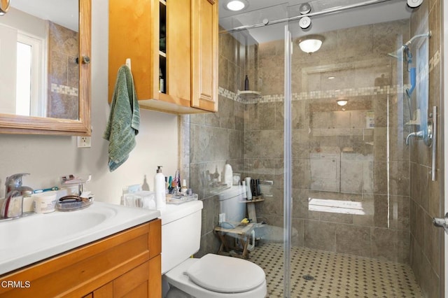 bathroom with vanity, an enclosed shower, and toilet