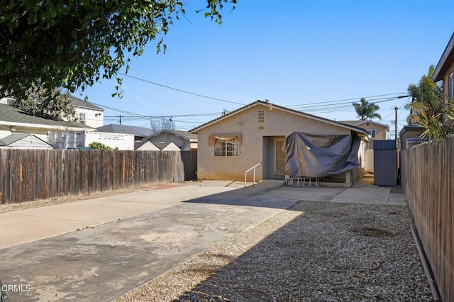 back of house with a patio