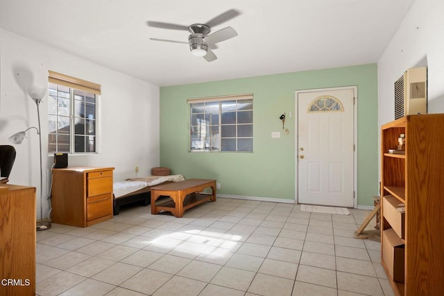 foyer featuring light tile patterned floors and ceiling fan