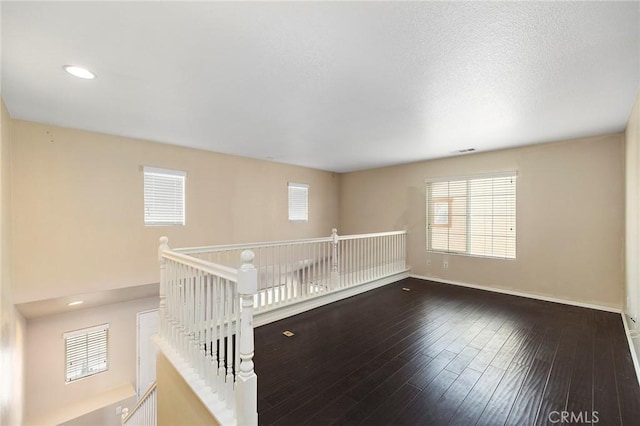 spare room featuring dark hardwood / wood-style flooring