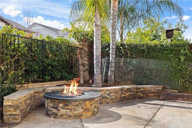 view of patio / terrace featuring an outdoor fire pit