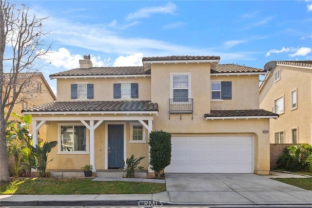 mediterranean / spanish home featuring a garage