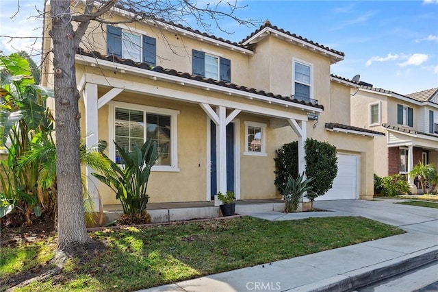 mediterranean / spanish-style house with a garage and a front yard