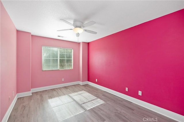 spare room featuring ceiling fan and hardwood / wood-style floors