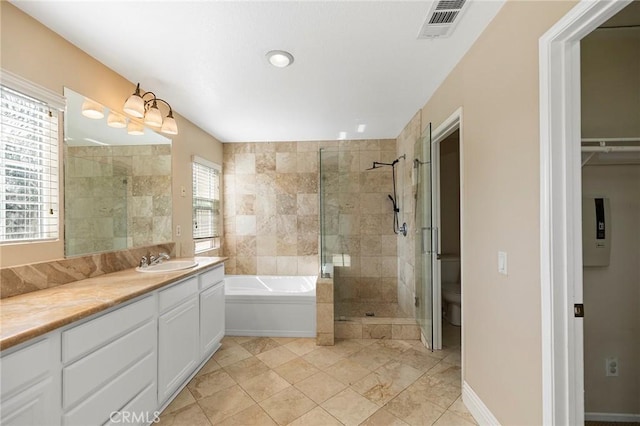 full bathroom with toilet, vanity, and shower with separate bathtub