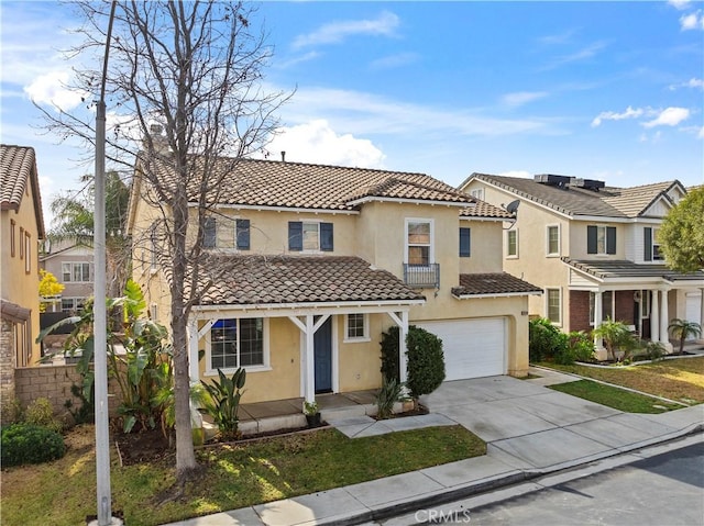 mediterranean / spanish house with a garage and a front lawn