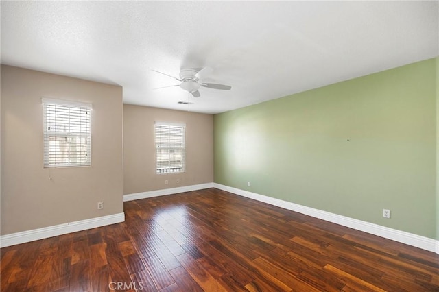 unfurnished room featuring ceiling fan and dark hardwood / wood-style floors