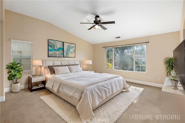 bedroom featuring lofted ceiling, light colored carpet, and ceiling fan