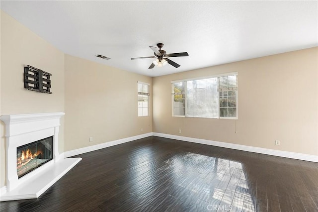 unfurnished living room featuring dark hardwood / wood-style floors and ceiling fan