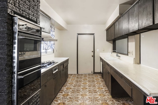 kitchen featuring dark brown cabinetry, sink, gas stovetop, black double oven, and dishwashing machine