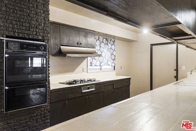 kitchen with dark brown cabinetry, sink, and black appliances