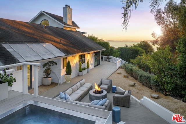 patio terrace at dusk with an outdoor fire pit