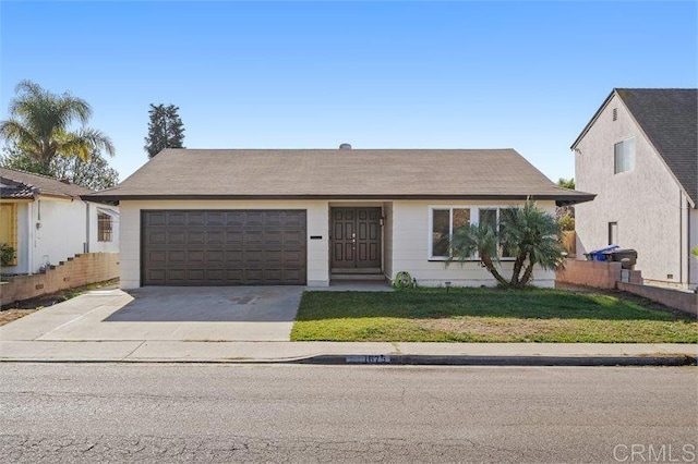 ranch-style house featuring a front yard and a garage