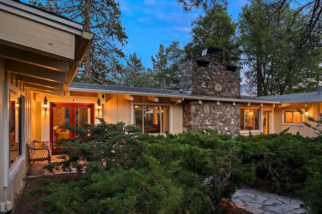 back house at dusk featuring french doors