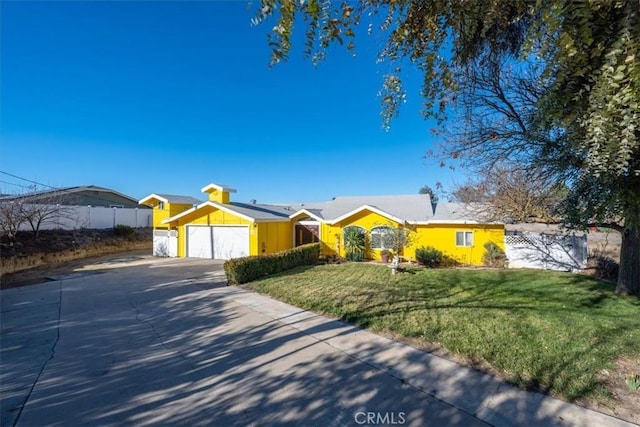 ranch-style home with a garage and a front lawn