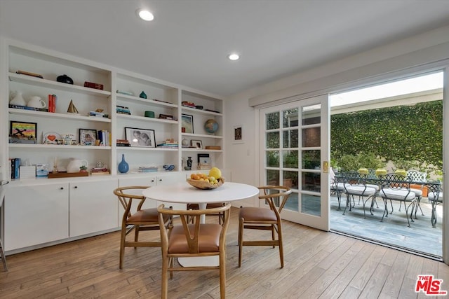 dining room with light wood-type flooring and french doors