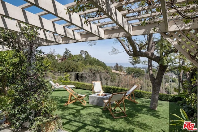 view of yard with an outdoor fire pit and a pergola