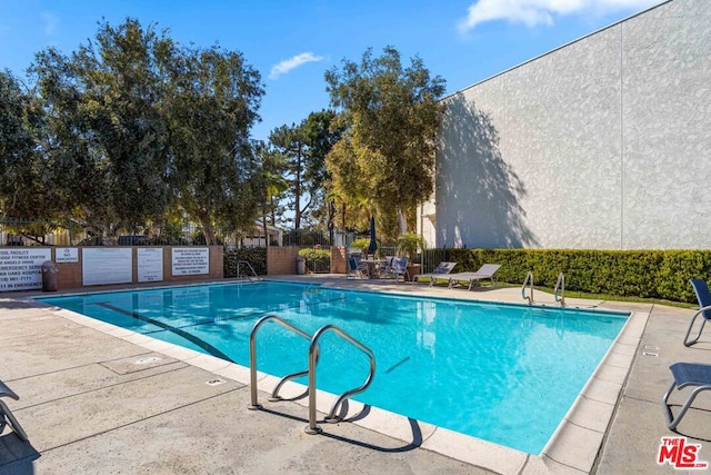 view of swimming pool with a patio