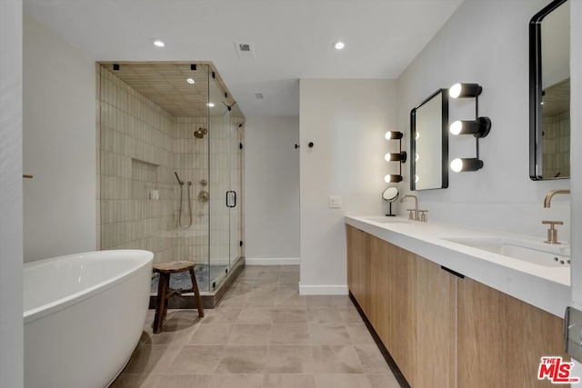 bathroom featuring vanity, independent shower and bath, and tile patterned flooring