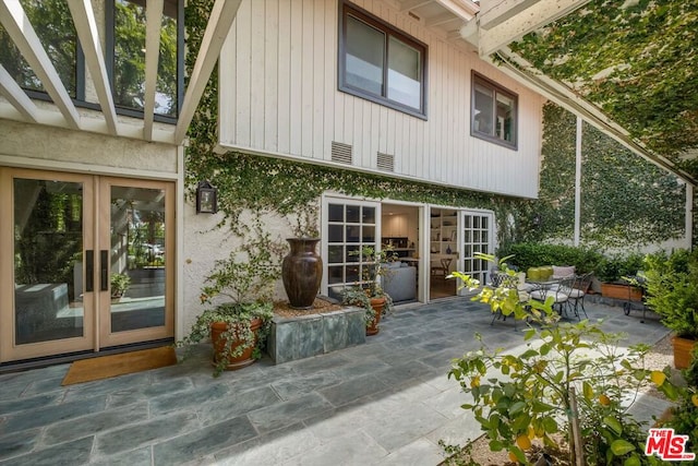 back of house featuring a patio area and french doors