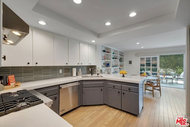 kitchen featuring dishwasher, extractor fan, white cabinetry, gray cabinets, and kitchen peninsula