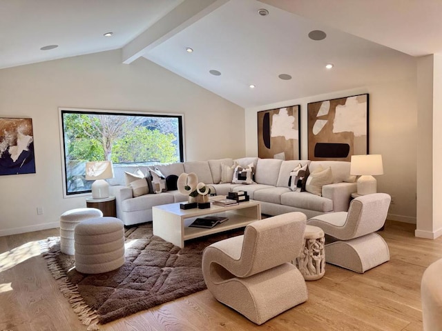 living room with light hardwood / wood-style floors and vaulted ceiling with beams