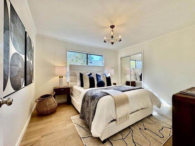 bedroom featuring crown molding, a chandelier, and light hardwood / wood-style flooring