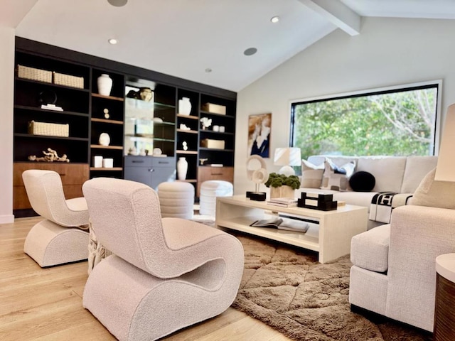 living room featuring hardwood / wood-style flooring, built in features, and vaulted ceiling with beams