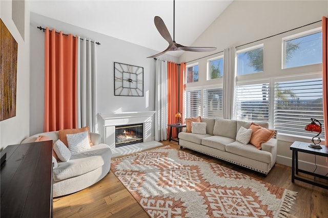 living room featuring ceiling fan, lofted ceiling, and wood-type flooring