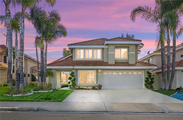 mediterranean / spanish home featuring a garage