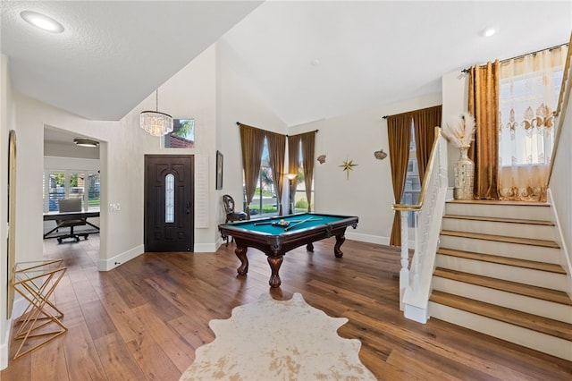 recreation room with wood-type flooring, a notable chandelier, a wealth of natural light, and pool table