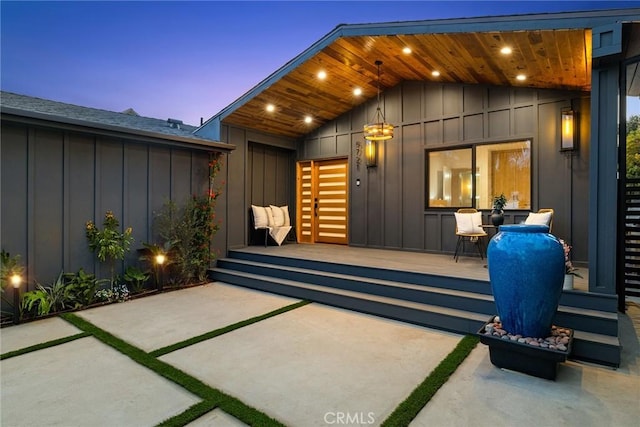 exterior entry at dusk featuring a patio area