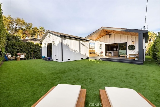 rear view of house featuring an outbuilding and a lawn