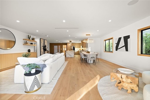 living room with a wealth of natural light and light hardwood / wood-style flooring