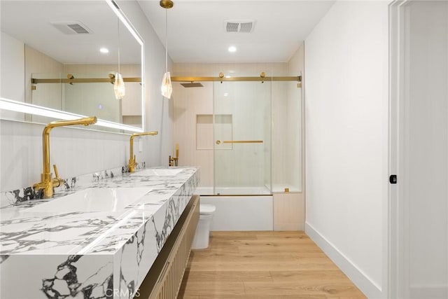 full bath with visible vents, a sink, toilet, and wood finished floors