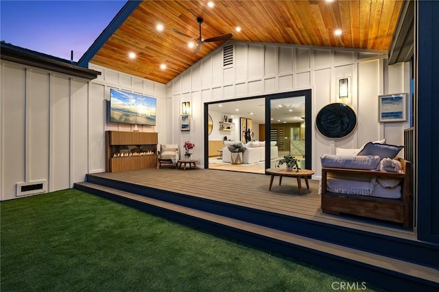 exterior space with visible vents, board and batten siding, and a wooden deck