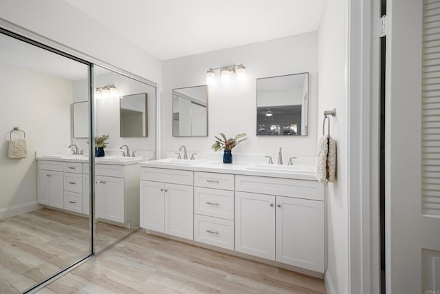 bathroom with vanity and hardwood / wood-style flooring