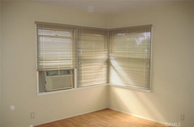 empty room featuring light wood-type flooring and cooling unit