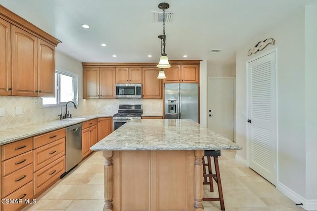 kitchen with decorative backsplash, stainless steel appliances, sink, pendant lighting, and a kitchen island