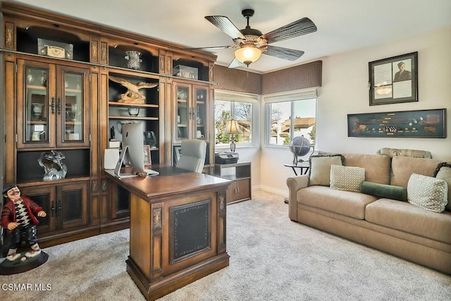 office space featuring ceiling fan and light carpet