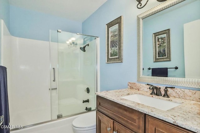 full bathroom featuring vanity, toilet, and combined bath / shower with glass door