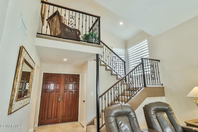 foyer entrance with a towering ceiling