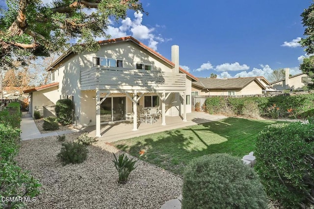 rear view of property with a patio area and a yard